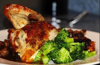 Roasted chicken breast and broccoli on a white plate, healthy paleo meal option