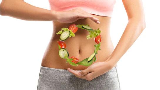 Woman's midsection with veggies forming a circle on stomach, gut health and nutrition concept